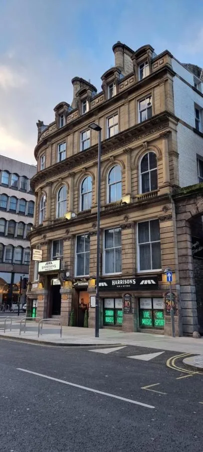 a building on the corner of a city street at Harrisons Aparthotel Liverpool in Liverpool