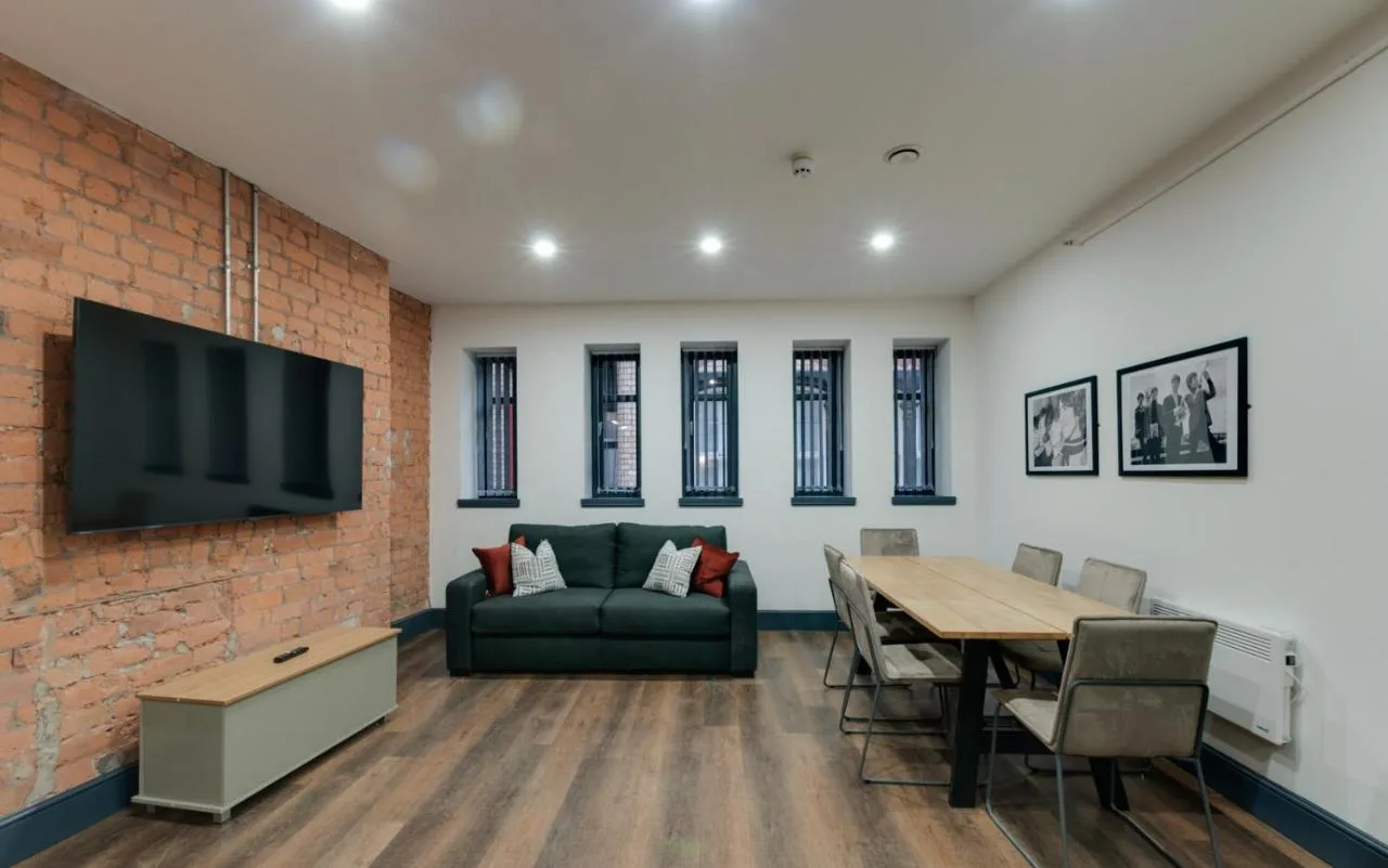 a living room with a couch and a table at Harrisons Aparthotel Liverpool in Liverpool
