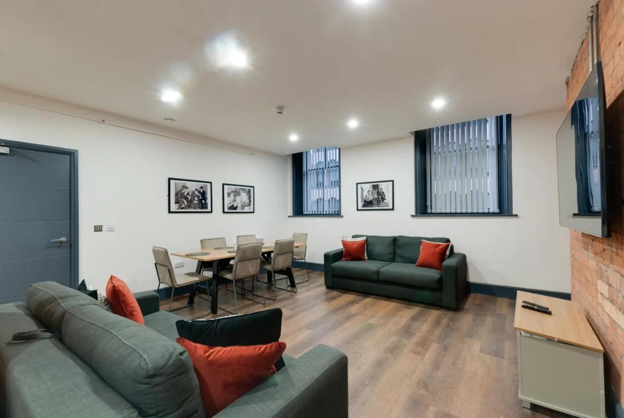 a living room with a couch and a dining room at Harrisons Aparthotel Liverpool in Liverpool